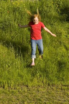 happy little girl is running of a hill