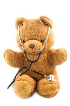 Bown teddybear acting as a doctor with a stetoscope isolated on white