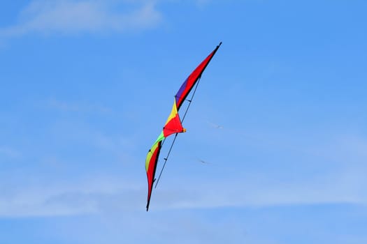 Colorful kite flying against the blue sky
