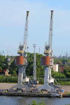 Two big cranes on the dock in a harbour

