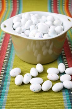 Miniature speckled easter eggs in a green bowl