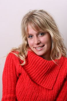 Blond Female model on a white background wearing a blue top