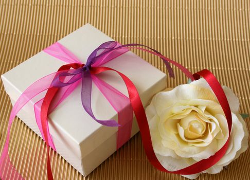 Cream colored gift box and a cream colored rose