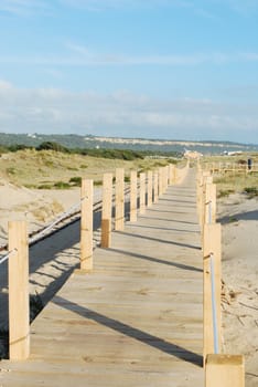 beautiful boardwalk through the dunes entering local beach