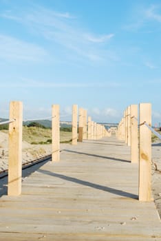 beautiful boardwalk through the dunes entering local beach