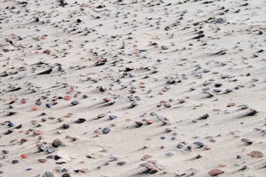 Natural sand and stone pattern on the beach, caused by the wind
