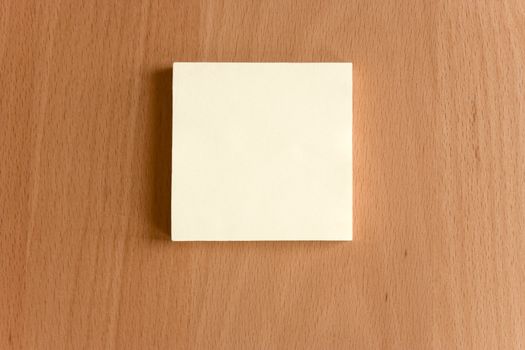  A post it note on a wooden table