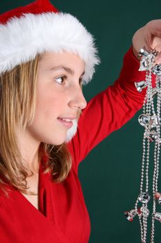 Beautiful teenager wearing a red shirt and christmas hat