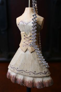 Wooden Jewelery stand with diamond necklace hanging