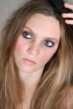 Beautiful female model with blue eyes and dark make up