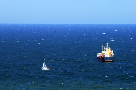 Aerial view at the sailing boat and big ship at the baltic sea, Poland
