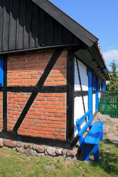 Timber framed traditional fisherman's house and a garden
