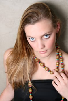 Beautiful female model with blue eyes and a string beads