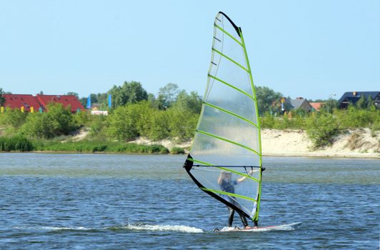 Man on the surfboard training at the sea bay
