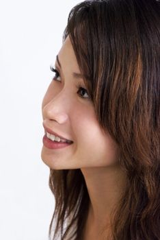 A young beautiful Asian woman smiling and looking up. Adobe RGB color profile.