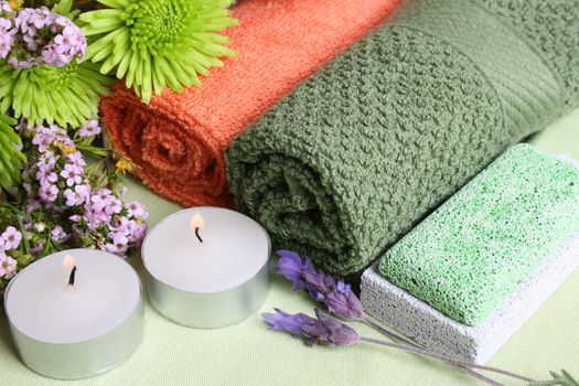 Spa Accessories setting with face cloths, candles and flowers