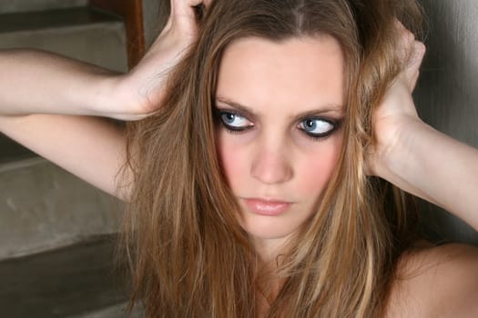 Beautiful female model with blue eyes and dark make up