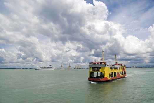 The Penang (Malaysia) ferry boat doing a crossing between Georgetown and Butterworth on a dramatically cloudy day. 