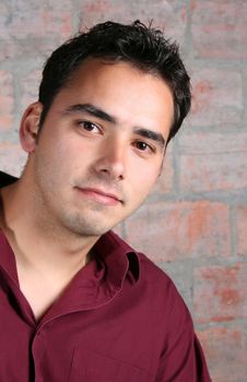 Male model against a rough brick wall background