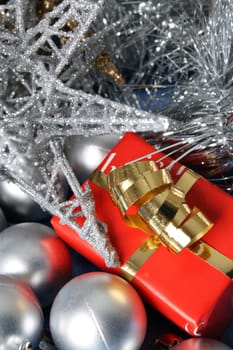 Small christmas gift amongst a variety of decorations