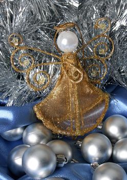 Golden Christmas Angel amongst other silver decorations
