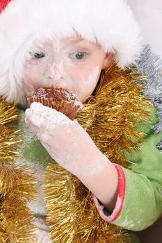 Toddler wearing a christmas hat, baking christmas cookies