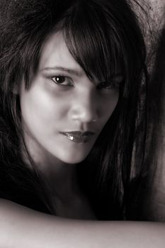 Beautiful young female model against a brick wall
