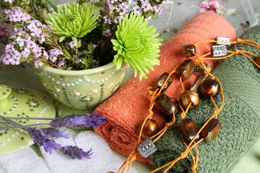 Spa Accessories setting with face cloths, beads and flowers