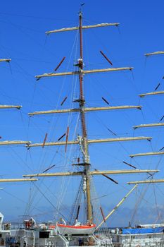 Rigging of big sailing ship against the blue sky background