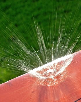 A drop hit my porch causing a big splash of water... Actually it is small, but the closeup makes it look big