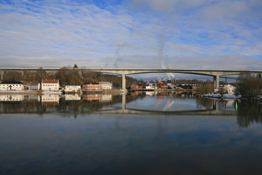 Houses reflecting in the quiet water in Paeddekummen, Norway