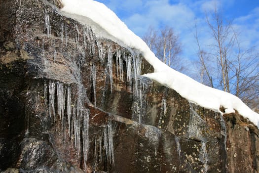 The sun melting the snow forming icicles