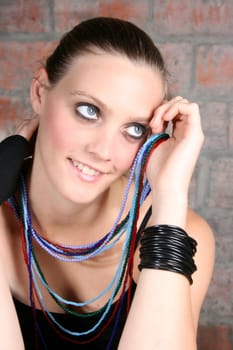 Beautiful model with blue eyes holding strings of beads