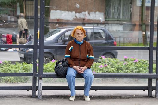 Old redhead lady waiting for bus in St.Petersburg
