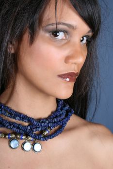 Beautiful young female model against a blue background