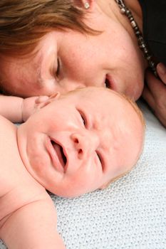 Tired mother and crying newborn baby, both fed-up