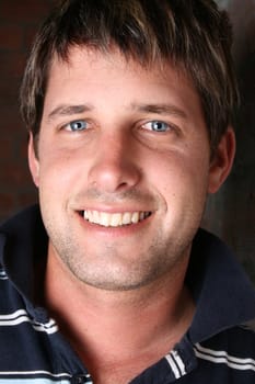 Male model against a rough brick wall background