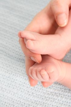 Feet of a baby in his mothers hand