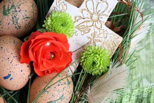 Decorated eggs in a wreath on a green background