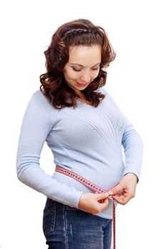 Pregnant woman measuring her belly