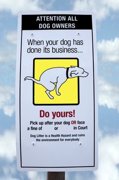 sign warning about fines for dogs fouling with cloudy background