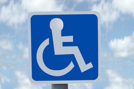 universal wheel chair sign with clouds in the background