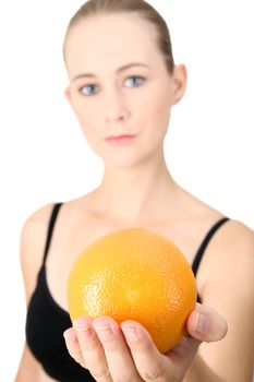Model holding an orange in her hand.  FOCUS ON ORANGE