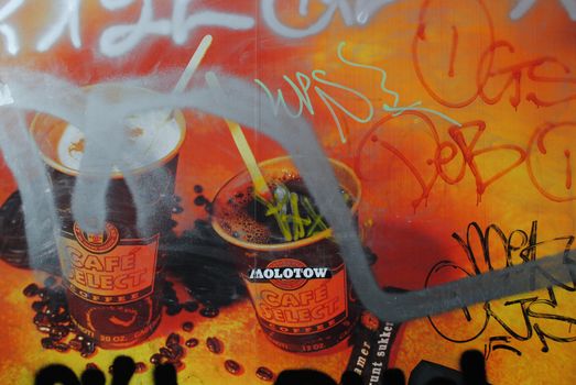 An advertisement covered in graffiti.