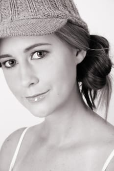 Beautiful young female model wearing a grey hat