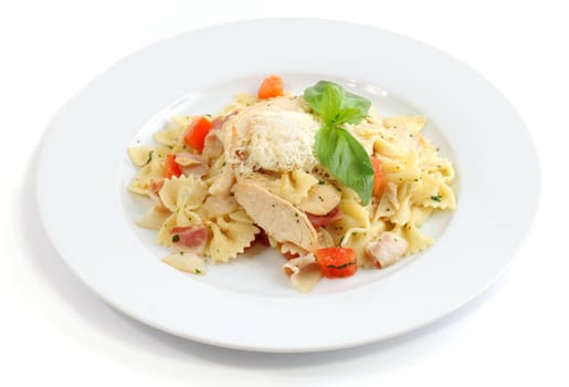 Italian dish: Farfalle with chicken, bacon and cheese on white background