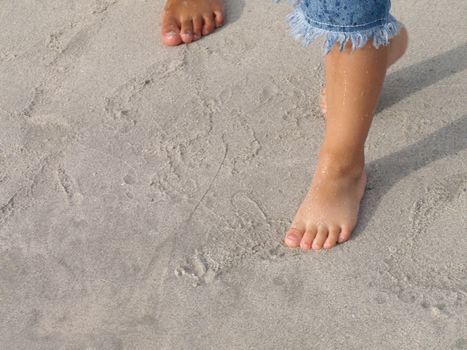 kids feets in the sand