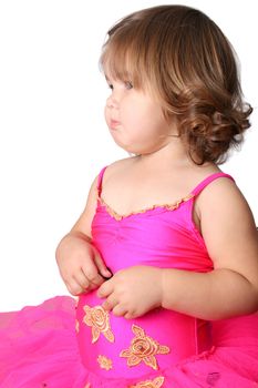 Little girl with short hair wearing a bright pink ballet outfit
