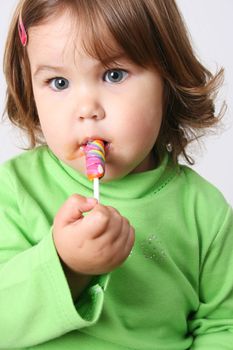 Toddler girl with chubby cheeks wearing a green top