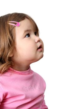 Toddler girl with chubby cheeks looking into the distance